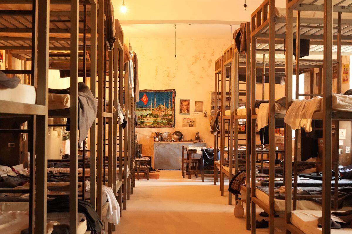 Clean shared hostel dormitory with wooden bunk beds